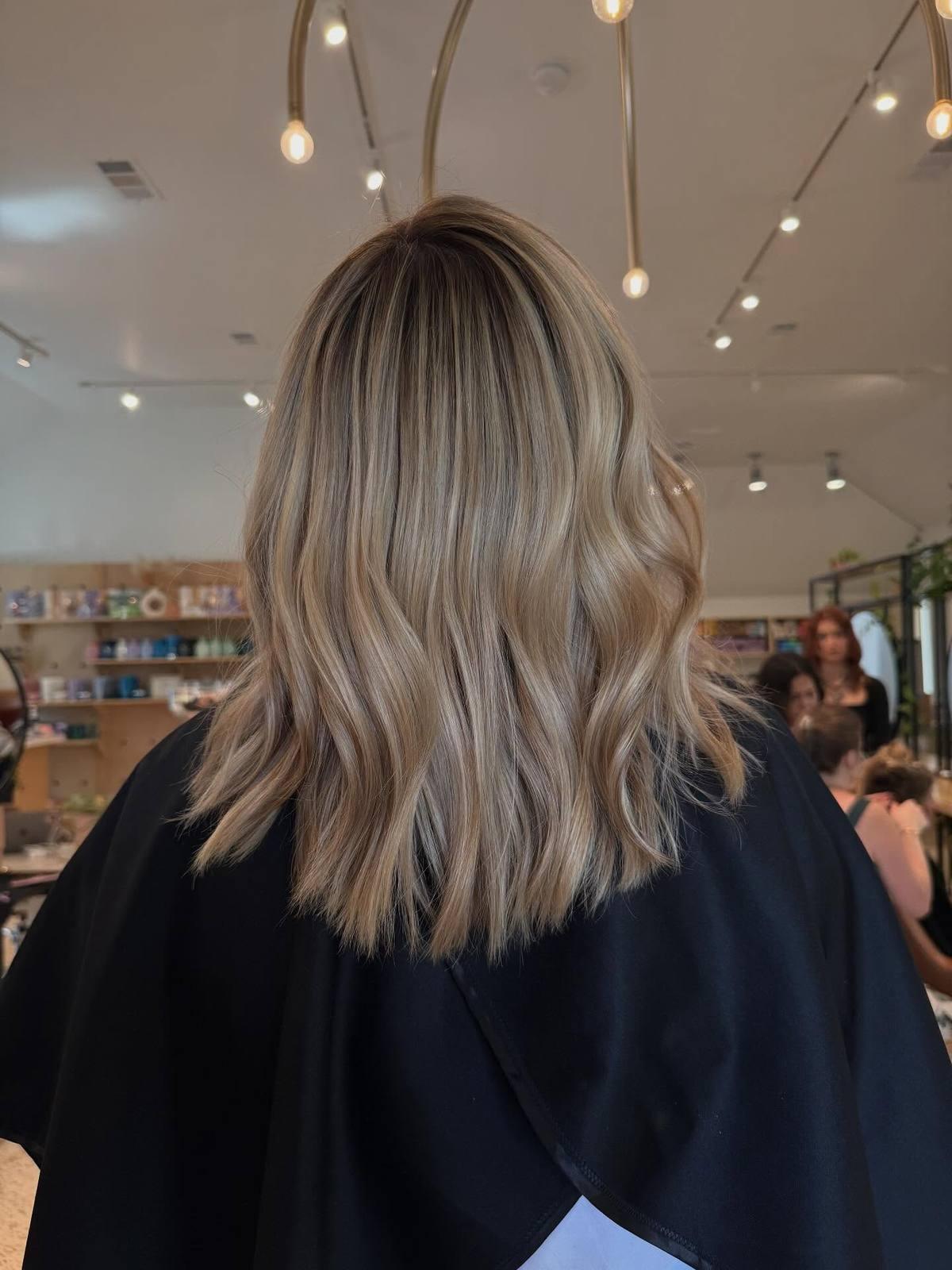 Blonde balayage lob with a smudged root