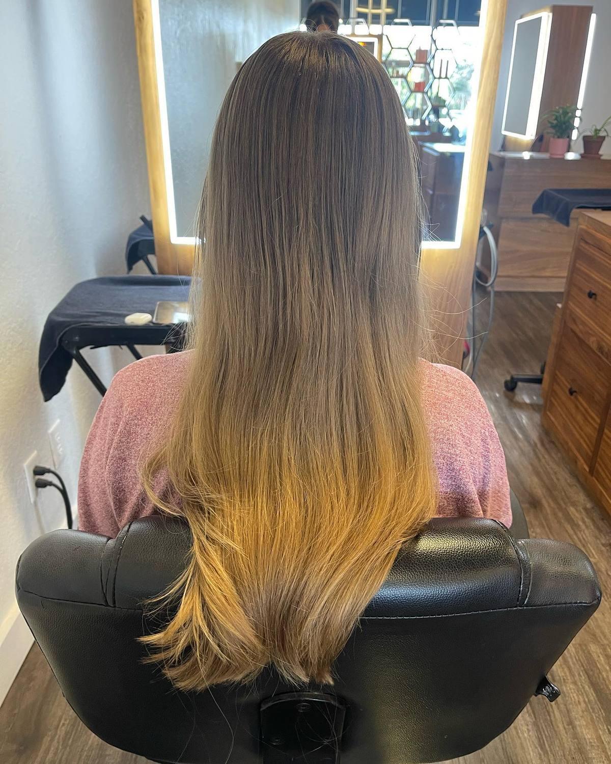 Long blonde ombre melting from a deep root