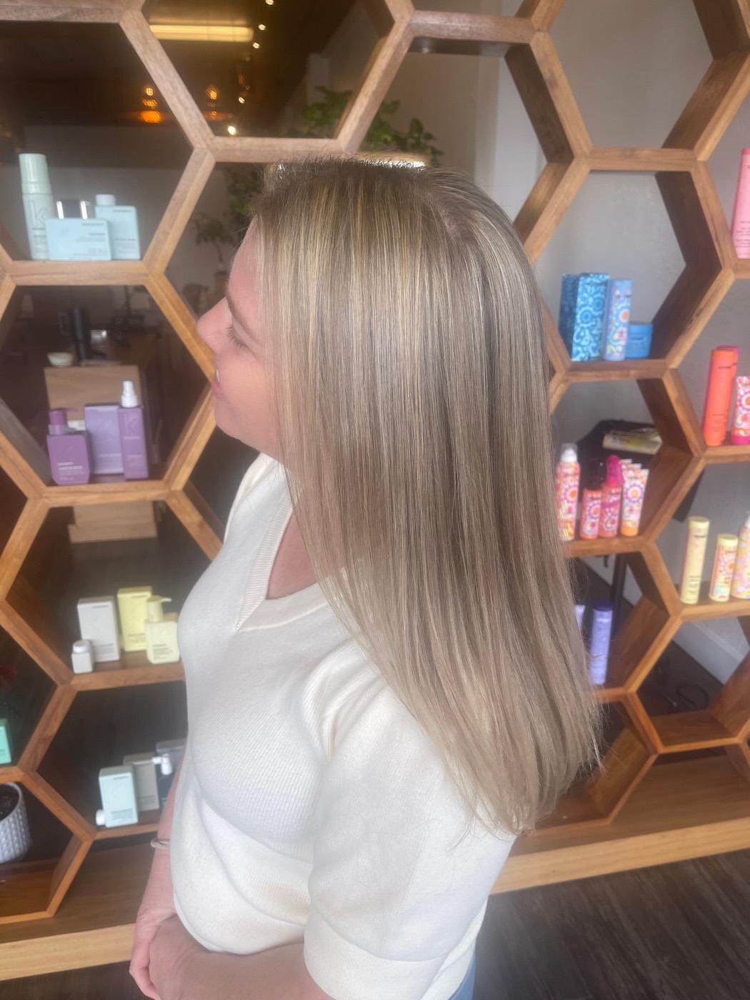 Sleek blonde highlights styled by Mya Binder at South Main District Salon