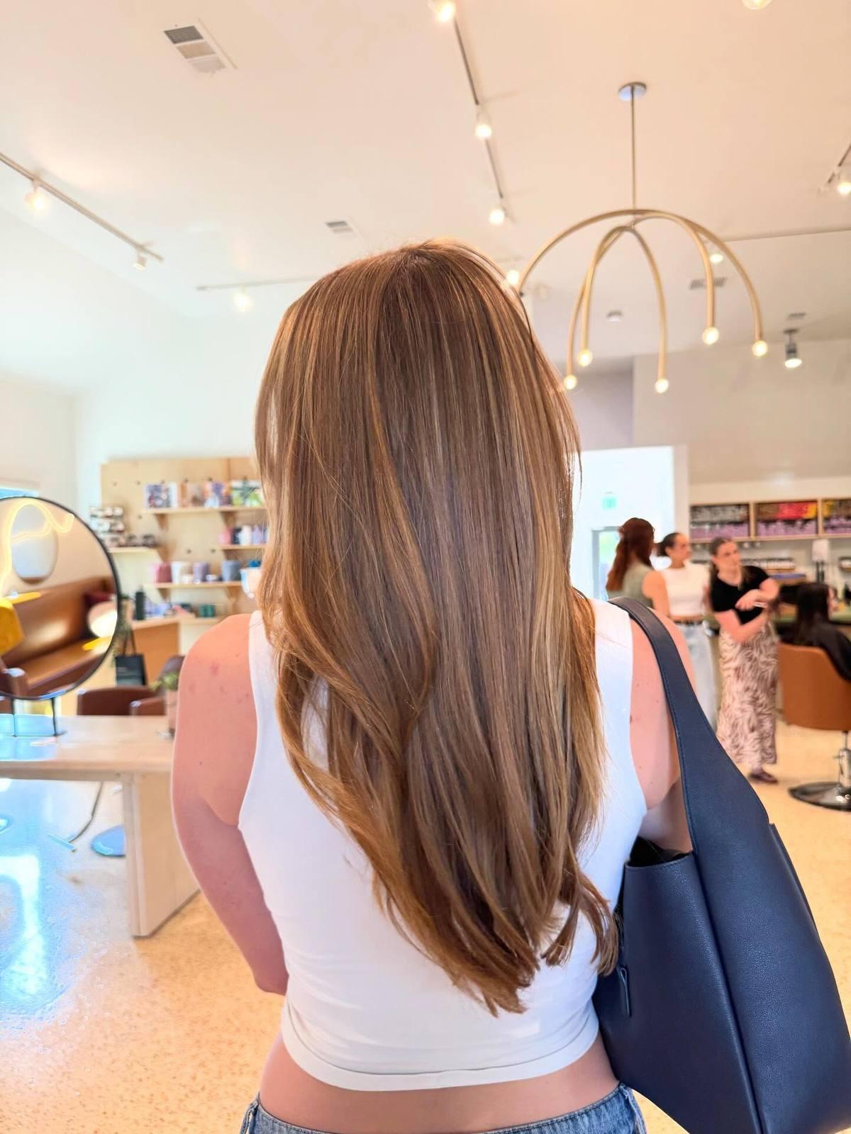 Long bronde with sun-kissed face-framing layers