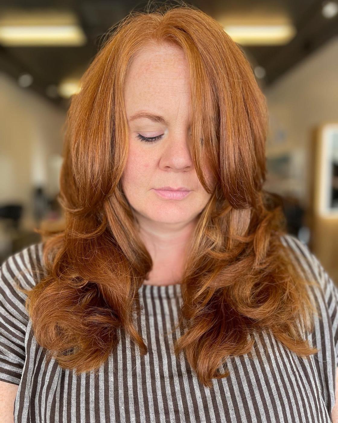 Warm copper red with a voluminous round-brush style